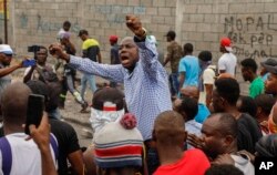 FILE — Former presidential candidate Moise Jean-Charles, center, chants anti-government slogans during a protest against Haitian Prime Minister Ariel Henry in Port-au-Prince, Haiti, February 5, 2024.