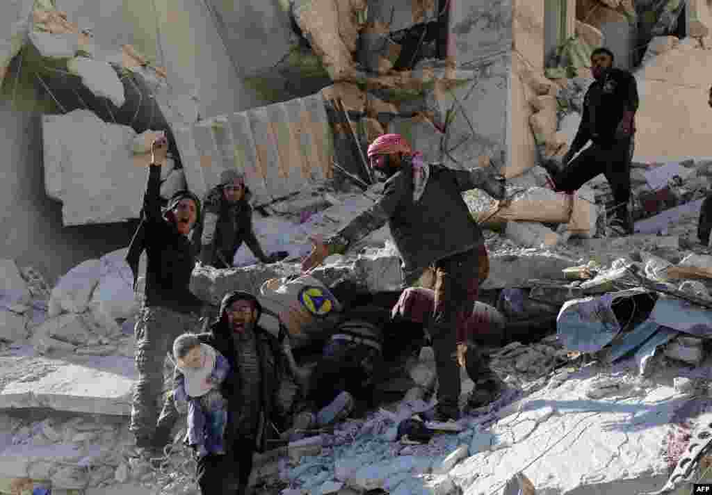 Civilians and rescue workers remove a toddler and search for other victims amid the rubble of a building following a reported air strike by Syrian government forces on the Sukkari neighborhood of Syria&#39;s northern city of Aleppo.