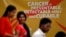 A flash mob participants walk in front of a hoarding spreading awareness on cancer in Hyderabad, India, February 3, 2012. 