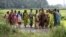 Indian women laborers return after a days work at a paddy field. Indians have been desperately waiting for the long-delayed deluge of this year's monsoon, July 24, 2012.
