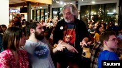 FILE- Supporters of Democratic 2020 U.S. presidential candidate Senator Bernie Sanders discuss what they saw in a screening of the tenth Democratic 2020 presidential debate from a watch party in Charleston, South Carolina.