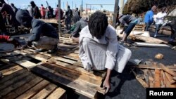 African migrants build a makeshift house after their houses burned, on the outskirts of Casablanca, Morocco, Oct. 29, 2018. 