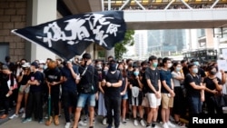 FILE - Supporters of jailed activist Edward Leung, gather outside the High Court as Leung appeals against a conviction and sentence, in Hong Kong, China October 9, 2019. Text on flag reads, "Liberate Hong Kong, the revolution of our times."