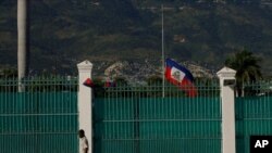 FILE - The Haitian flag flies at half-staff at the Presidential Palace in Port-au-Prince, Haiti, July 10, 2021, three days after President Jovenel Moise was assassinated in his home.