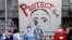 Health care workers and other staff gather at a distance at Harborview Medical Center in a demonstration asking management to do more to protect staff, patients and the public amid the COVID-19 pandemic, May 14, 2020, in Seattle.