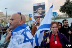 FILE —A demonstrator holds an image of 22-year-old Israeli hostage Evyatar David as family members and supporters take part in a protest calling for their release outside the Prime Minister's office in Jerusalem on November 18, 2023.