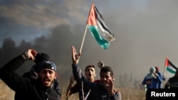 Des manifestants palestiniens lors d'affrontements avec les troupes israéliennes au cours du "jour de rage" appelé par les Palestiniens pour dénoncer la décision américaine de reconnaître Jérusalem comme capitale d'Israël, à l'est de Gaza, le 8 décembre 2017.