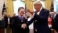 President Donald Trump shakes hands with economist Arthur Laffer after awarding him the Presidential Medal of Freedom, June 19, 2019, in the Oval Office of the White House in Washington.