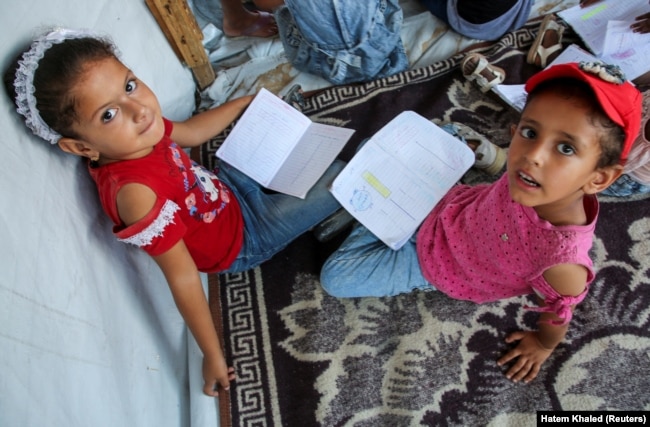 Palestinian students attend a class in a tent set up on the rubble in Khan Younis, in the southern Gaza Strip, September 4, 2024. (REUTERS/Hatem Khaled)