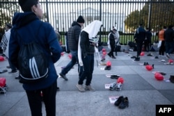 FILE .—People pray on Pennsylvania Avenue in front of the White House before a rally supporting Israel during its conflict with Hamas November 14, 2023, in Washington, DC.