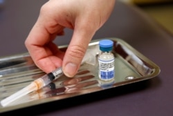 FILE PHOTO: A vial of the measles, mumps, and rubella virus (MMR) vaccine is pictured at the International Community Health Services clinic in Seattle, Washington, March 20, 2019.