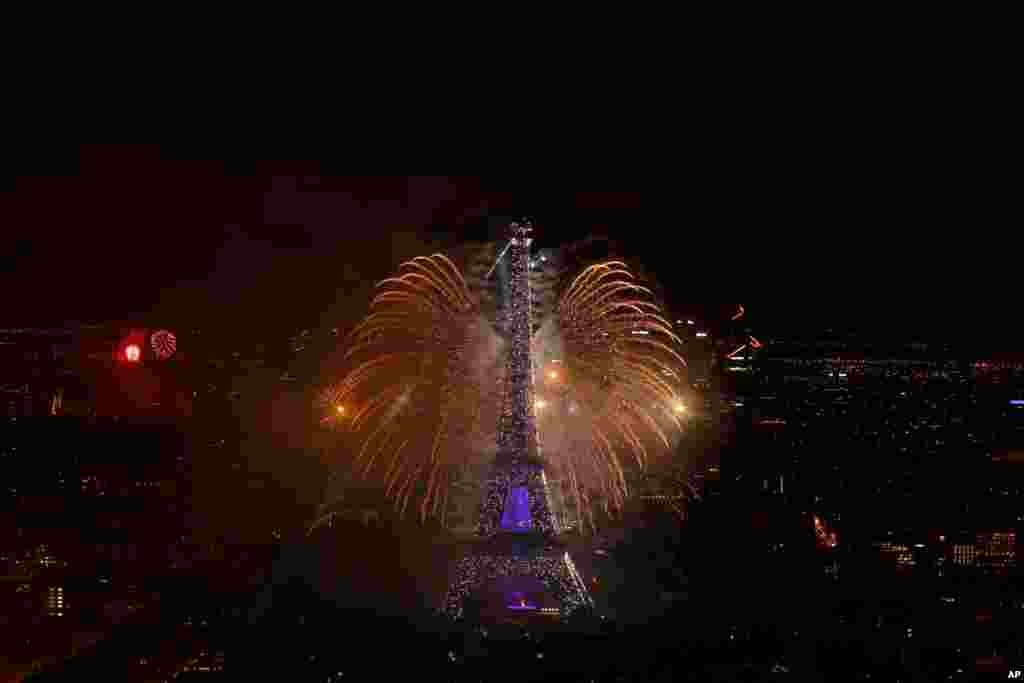 A view of the fireworks display by the Eiffel tower on Bastille Day, in Paris, France.