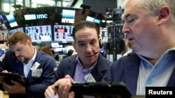 Traders work on the floor of the New York Stock Exchange in New York City, June 10, 2016.