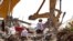 FILE - Rescuers from Pennsylvania are seen in the rubbles of the Champlain Towers South collapse, in Surfside, Florida, July 08, 2021. (Pedro Portal/Miami Herald vía AP)