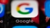 FILE- This April 26, 2017, file photo shows a Google icon on a mobile phone in Philadelphia. Google is spearheading an educational campaign to teach pre-teen children how to protect themselves from scams, predators and other trouble. The program announced Tuesday, June 6, is called “Be Internet Aware.” (AP Photo/Matt Rourke, File)