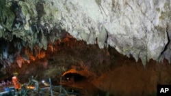 A rescuer works at the entrance to a cave complex where 12 soccer team members and their coach went missing, in Mae Sai, Chiang Rai province, in northern Thailand Saturday, June 30, 2018.