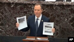 In this image from video, House impeachment manager Rep. Adam Schiff holds redacted documents as he speaks during the impeachment trial of President Donald Trump, in the Senate at the Capitol in Washington, Jan. 22, 2020. (U.S. Senate TV via AP)