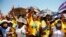 Members of the African National Congress (ANC) react to the arrival of South African President Cyril Ramaphosa during their party’s door-to-door political campaign ahead of the local government elections in Mabopane township north of Pretoria, Oct. 15, 2021.