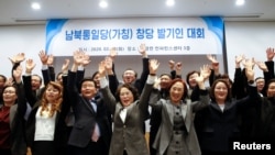 A group of North Korean defectors pose for photographs during the launching ceremony of their political party South-North Unification Party, ahead of the country's general election in April, in Seoul, South Korea, February 18, 2020. REUTERS/Heo Ran