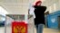 A young man casts his ballots during parliamentary and local elections, at a polling station outside St. Petersburg, Russia, Sept. 17, 2021. 