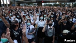 Pro-democracy protesters show the three-finger salute during an anti-government protest, in Bangkok, Thailand, Oct. 19, 2020.