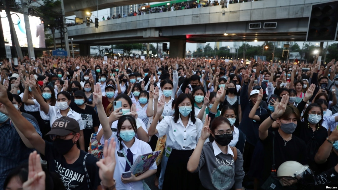Pro-democracy protesters show the three-finger salute during an anti-government protest, in Bangkok, Thailand, Oct. 19, 2020.