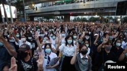 Pro-democracy protesters show the three-finger salute during an anti-government protest, in Bangkok, Thailand, Oct. 19, 2020.