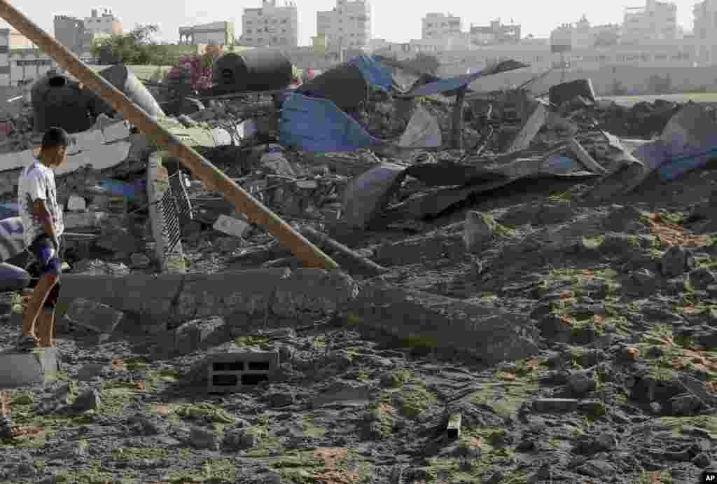 A Palestinian checks the damages of a Hamas training camp following an Israeli air strike on it early morning in Gaza City, July 3, 2014.