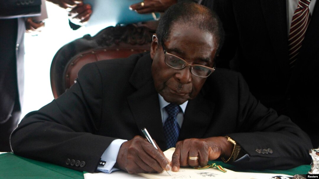 Zimbabwe President Robert Mugabe signs the country's new constitution into law in the capital Harare, replacing a 33-year-old document forged in the dying days of British colonial rule and paving the way for elections later this year, May 22, 2013.