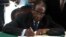 Zimbabwe President Robert Mugabe signs the country's new constitution into law in the capital Harare, replacing a 33-year-old document forged in the dying days of British colonial rule and paving the way for elections later this year, May 22, 2013.