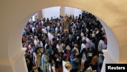 FILE - Devotees pray during the reopening ceremony of the St. Anthony's Shrine, one of the churches attacked in the April 21st Easter Sunday bombings in Colombo, Sri Lanka, June 12, 2019.