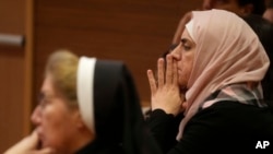 FILE - Participants in the conference about women leaders mark International Women's Day 2024, at the Vatican, March 6, 2024. 