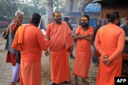 FILE—In this picture taken on March 14, 2024, Hindu holymen stand along a street at Rampur in India's Uttar Pradesh state.