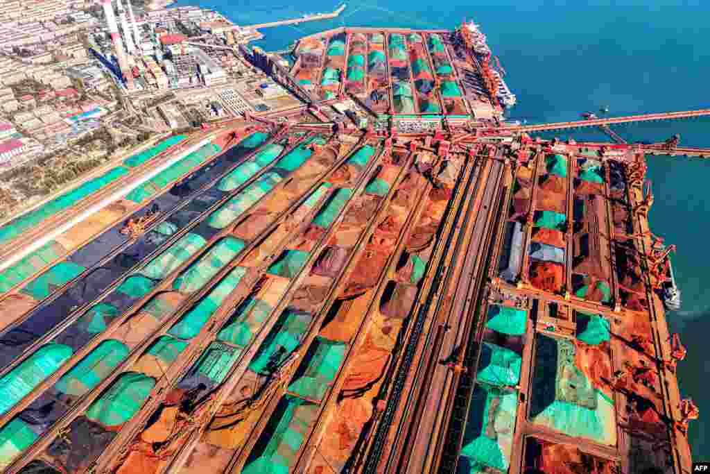 An aerial view shows imported iron ore piled up at a port in Qingdao, in China&#39;s eastern Shandong province.