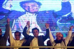 Chairman of Pakistan Peoples Party, Bilawal Bhutto Zardari , center, joins hands with other opposition parties leaders during a protest in Karachi on July 25, 2019.