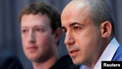 FILE - Russian entrepreneur and venture capitalist Yuri Milner (R) speaks while Facebook CEO Mark Zuckerberg looks on at the Life Sciences Breakthrough Prize announcement in San Francisco, California, Feb. 20, 2013. 