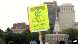 FILE - Protesters assembled by a majority Jewish group called Never Again Is Now demonstrate near Independence Hall in Philadelphia, July 4, 2019.