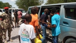 FILE - Children between the ages of seven and 18, cleared of ties with Boko Haram, get in a car being escorted by military personnel in Maiduguri, July 9, 2018.