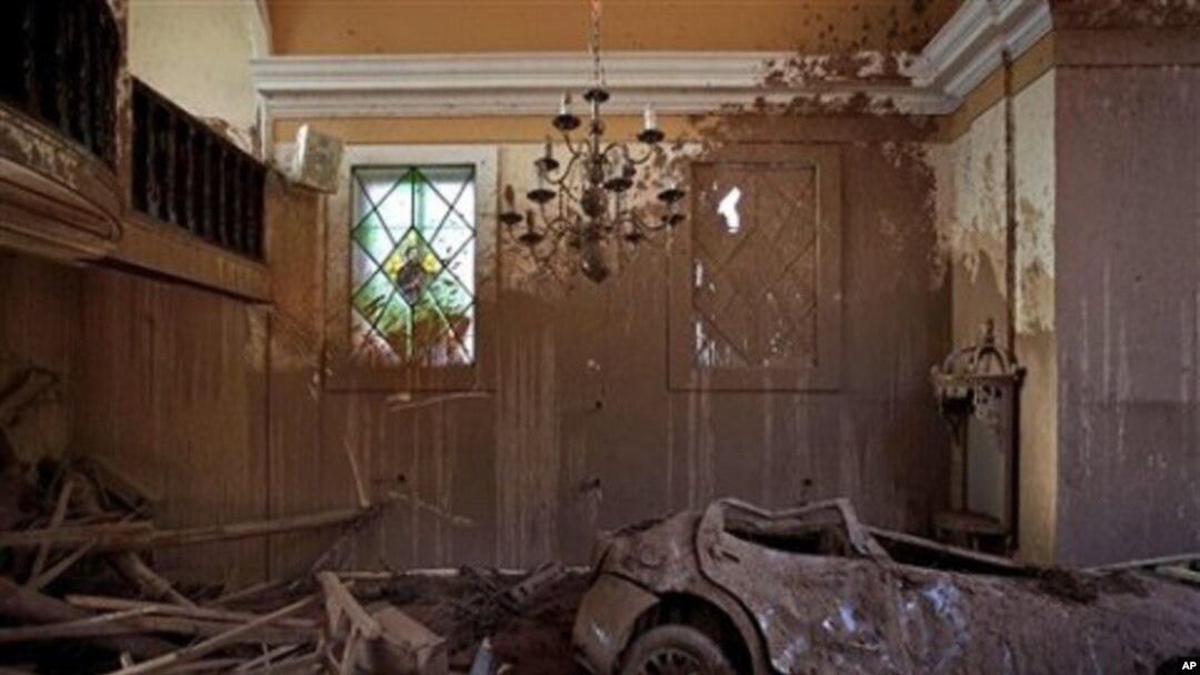 A car, dragged inside a church by a mudslide, is seen in Nova Friburgo, Brazil, 21 Jan 2011.