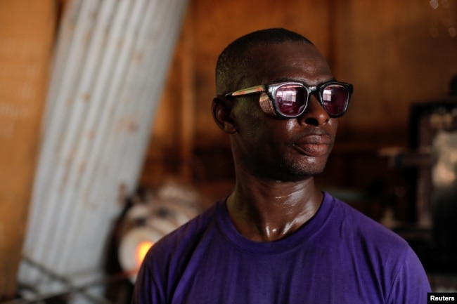 Tetteh is teaching young people how to make items from recycled glass at his glassware manufacturing workshop in Krobo Odumase, Ghana March 15, 2022. (REUTERS/Francis Kokoroko)