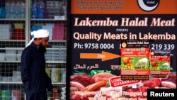 A man walks past a shop selling 'Halal meat' in the western Sydney suburb of Lakemba, Sept. 25, 2014. 