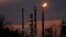 FILE - Stacks and burn-off from the ExxonMobil refinery are seen at dusk in St. Bernard Parish, Louisiana, Feb. 13, 2015. 