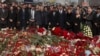 FILE— A group of ambassadors of foreign diplomatic missions attend a laying ceremony at a makeshift memorial in front of the Crocus City Hall on the western outskirts of Moscow, Russia, March 30, 2024.