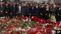 FILE— A group of ambassadors of foreign diplomatic missions attend a laying ceremony at a makeshift memorial in front of the Crocus City Hall on the western outskirts of Moscow, Russia, March 30, 2024.