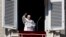 Pope Francis waves as he arrives to recite the Angelus noon prayer from the window of his studio overlooking St.Peter's Square, at the Vatican, Nov. 11, 2018.