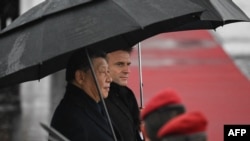 Chinese President Xi Jinping, left, and French President Emmanuel Macron attend a ceremony before Xi's departure, at the Tarbes-Lourdes airport, southwestern France, on May 7, 2024.