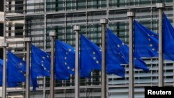 European Union flags are seen outside the European Commission headquarters in Brussels, Sept. 10, 2014. 