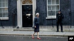FILE - British Prime Minister Theresa May is seen walking outside 10 Downing Street in London.