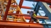 An Iranian construction worker walks on a steel I-beam at a building site in Baghdad, June 28, 2018.