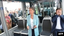 French Minister of Ecological and Inclusive Transition Nicolas Hulot, right, is in a tram next to French Minister of Transport Elisabeth Borne, center, upon arrival in Bordeaux after the inauguration of a new TGV high-speed train line from Paris, July 1, 2017.